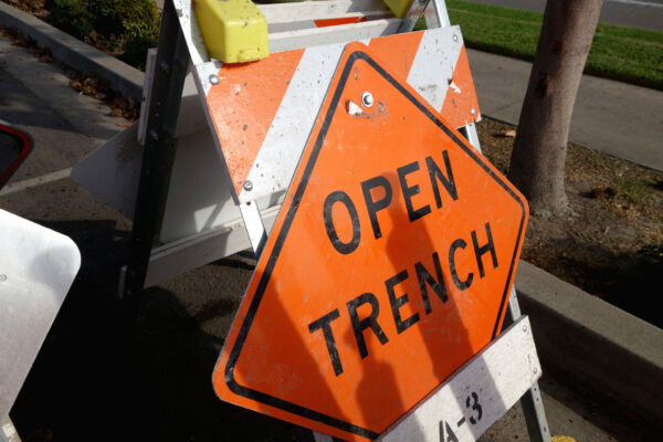 open trench sign and road barricade