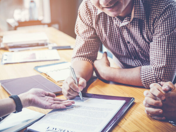 business partners signing contract to borrow money from investor to invest at own business business partners signing contract to borrow money from investor to invest at own business